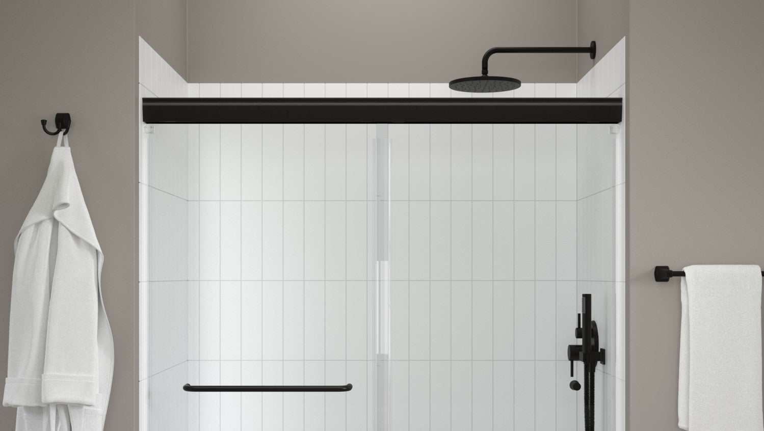 Modern shower setup with black fixtures and white towels.