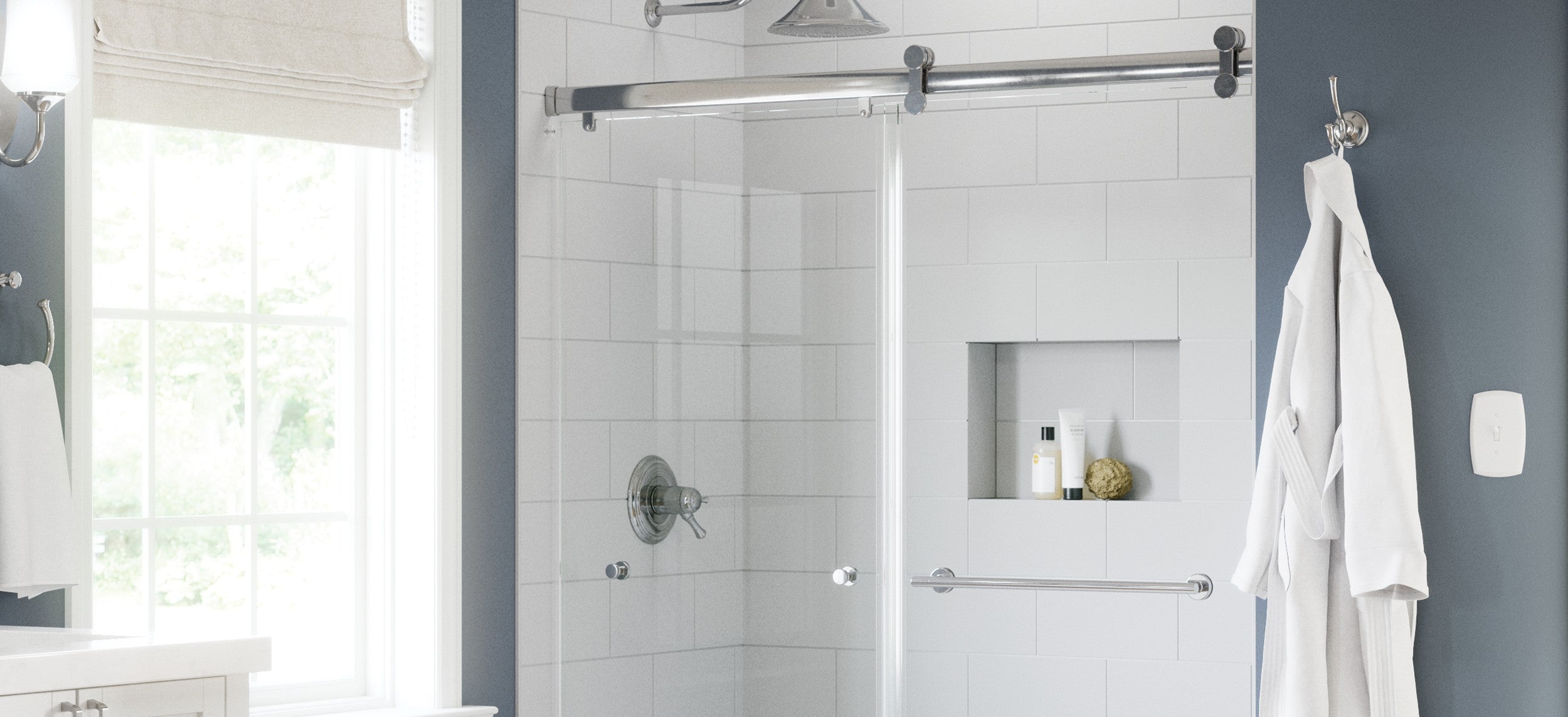 Bathroom with a shower enclosure, towel rack, and bathrobe.